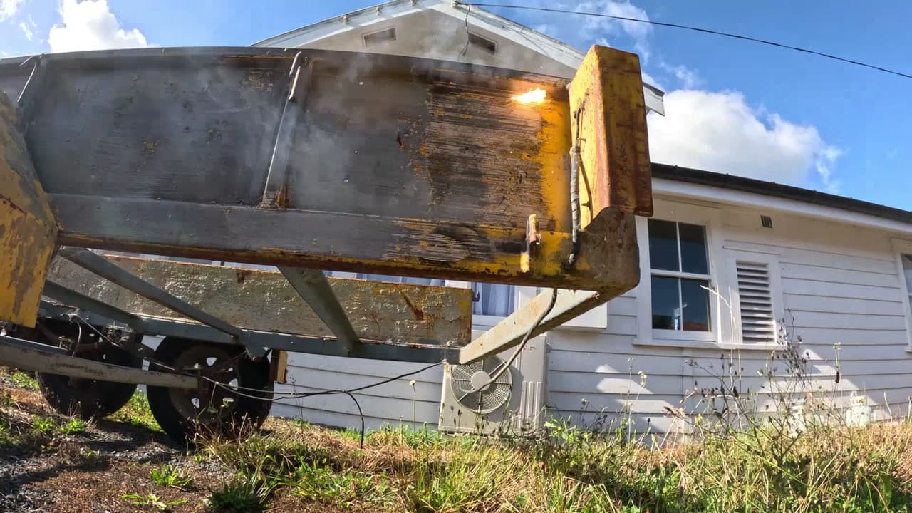 Mid-treatment — bare metal emerging through paint layers